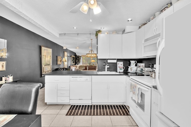 kitchen with white cabinets, white appliances, sink, ceiling fan, and a textured ceiling