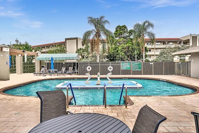 view of swimming pool with a patio area