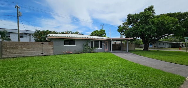 view of front of house with a front lawn and a carport