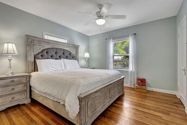 bedroom with dark hardwood / wood-style floors and ceiling fan