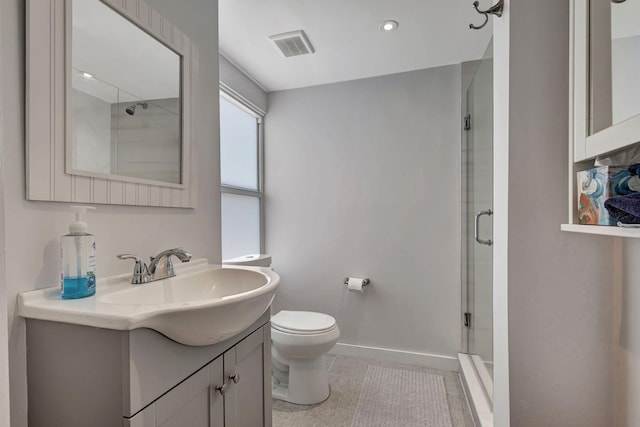 bathroom with tile patterned flooring, a shower with door, toilet, and vanity