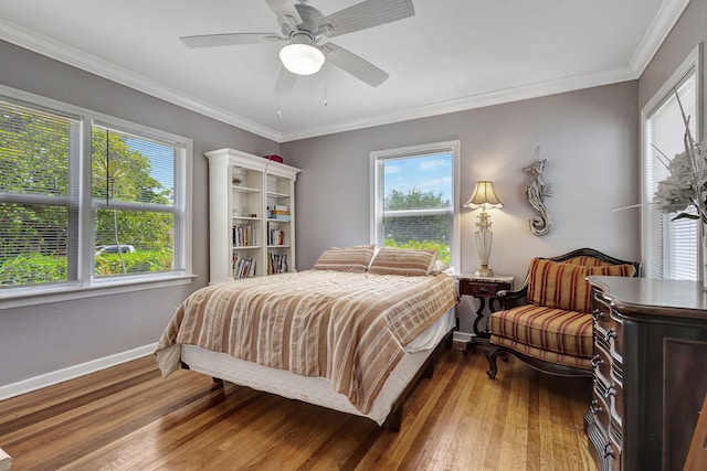 bedroom featuring crown molding, multiple windows, ceiling fan, and wood-type flooring