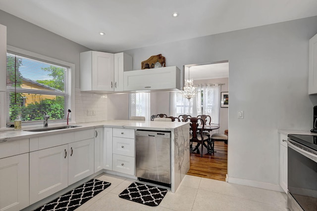 kitchen with light tile patterned flooring, tasteful backsplash, white cabinetry, sink, and stainless steel appliances