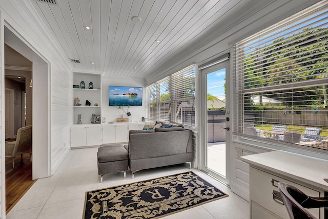 living room with a wealth of natural light, built in shelves, light hardwood / wood-style floors, and wooden ceiling