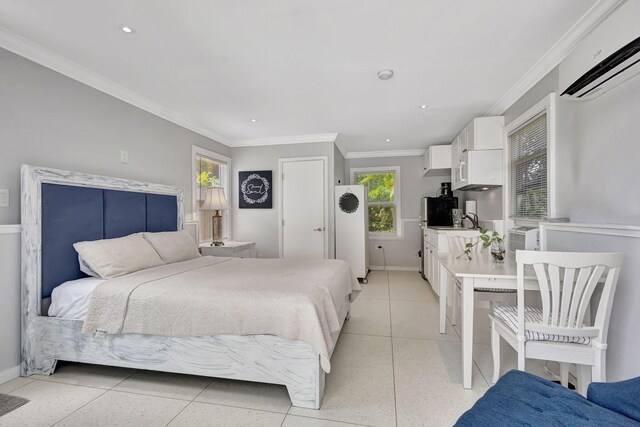 bedroom featuring sink, a wall unit AC, light tile patterned floors, and ornamental molding