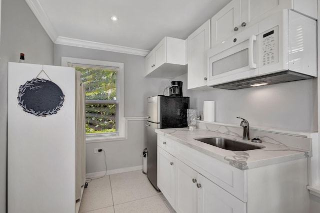 kitchen featuring white appliances, sink, light stone counters, light tile patterned floors, and crown molding