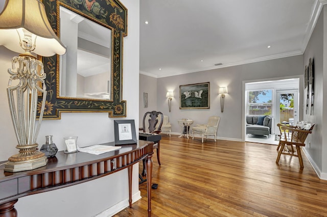 foyer featuring ornamental molding, wood-type flooring, and a notable chandelier