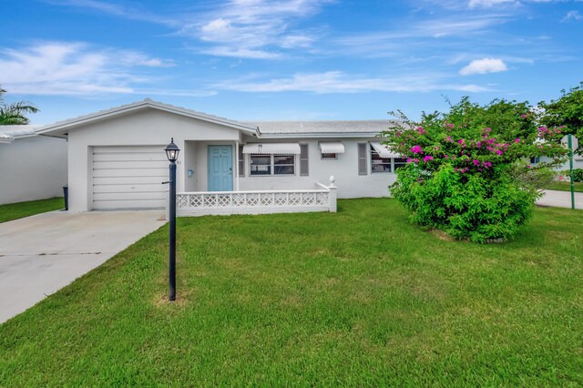 ranch-style house with a garage and a front lawn