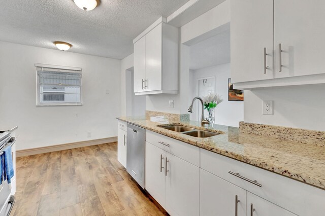 kitchen with sink, dishwasher, light stone counters, light hardwood / wood-style floors, and white cabinets