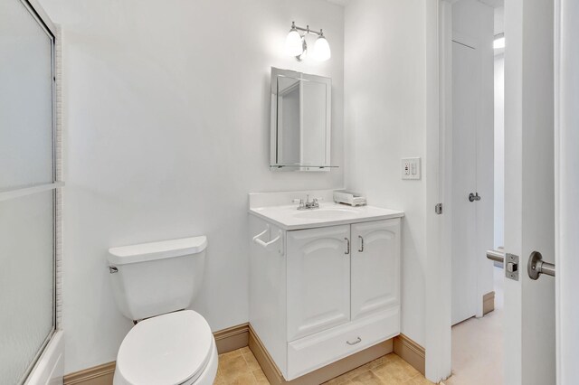 full bathroom with tile patterned floors, combined bath / shower with glass door, vanity, and toilet