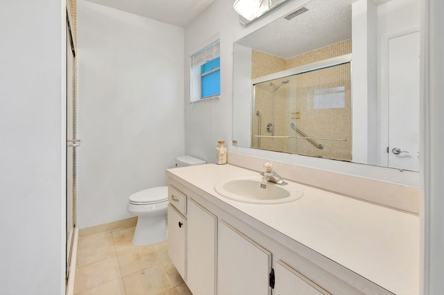 bathroom featuring vanity, tile patterned flooring, an enclosed shower, and toilet