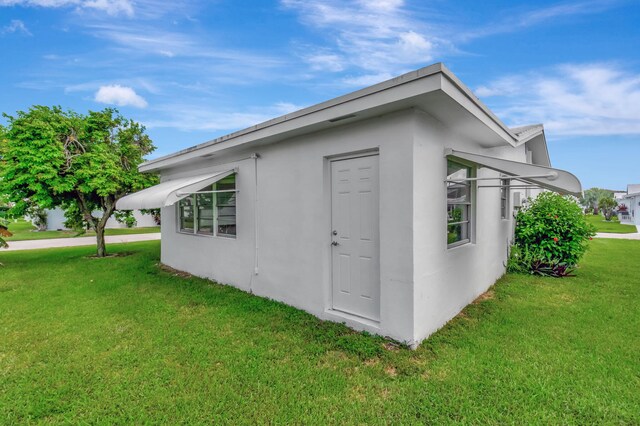 view of side of property with a lawn