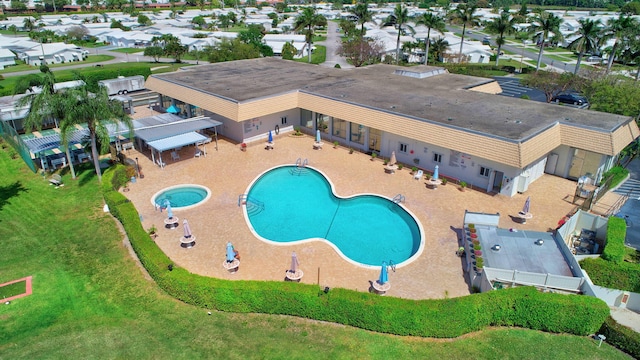 view of pool with a lawn and a patio