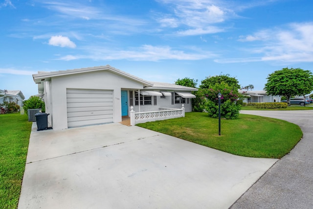 single story home featuring a garage and a front yard