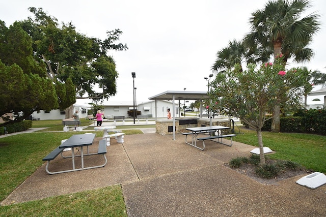 view of home's community featuring a lawn and a patio