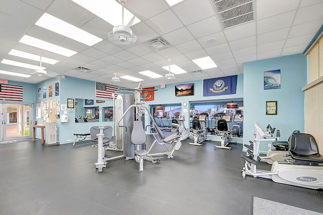 gym featuring ceiling fan and a paneled ceiling