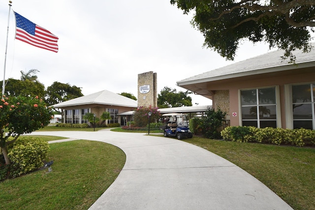 view of home's community with a yard and a carport