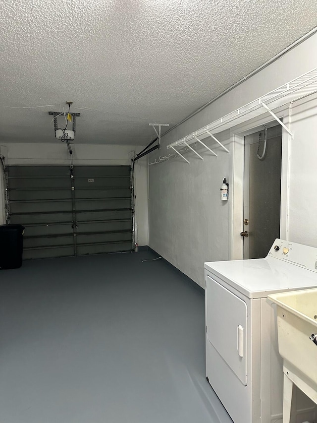 washroom featuring washer / clothes dryer, a textured ceiling, and sink