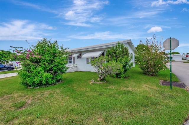 view of side of home with a lawn