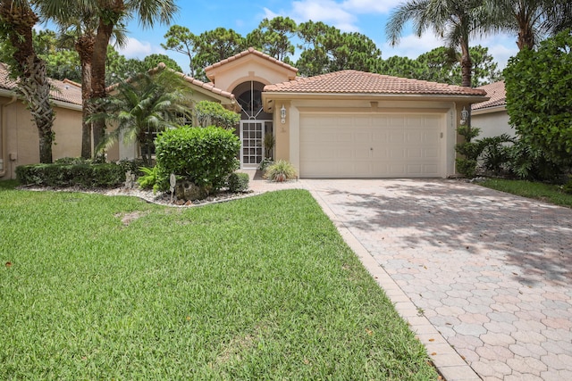 mediterranean / spanish-style house featuring a garage and a front yard