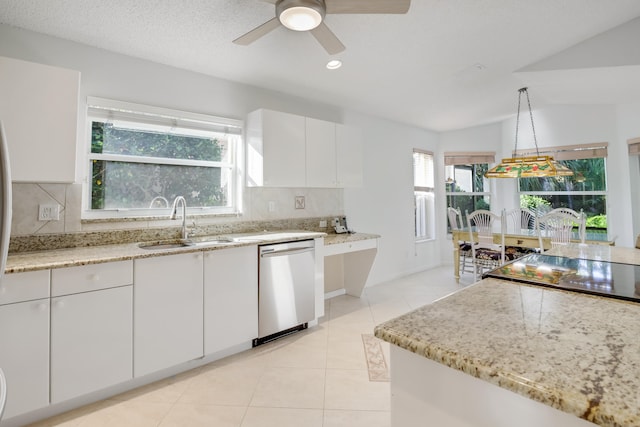 kitchen featuring white cabinetry, sink, hanging light fixtures, stainless steel dishwasher, and lofted ceiling