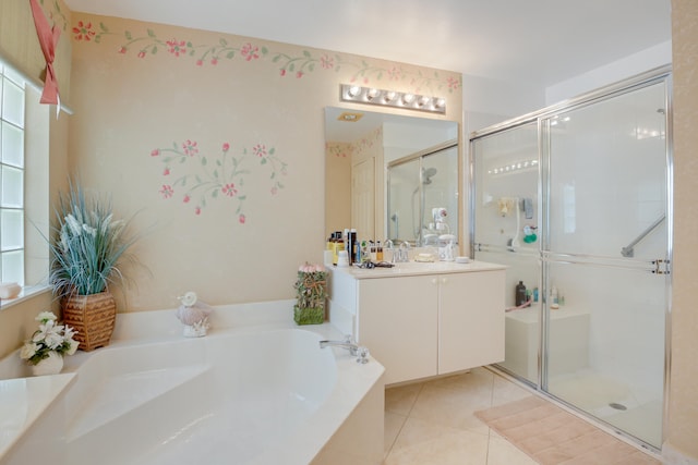 bathroom featuring tile patterned flooring, vanity, separate shower and tub, and a wealth of natural light