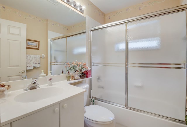 full bathroom with shower / bath combination with glass door, vanity, and toilet