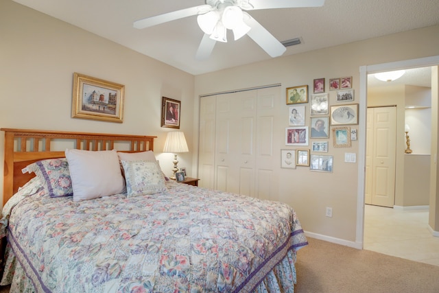 bedroom with light carpet, a closet, and ceiling fan