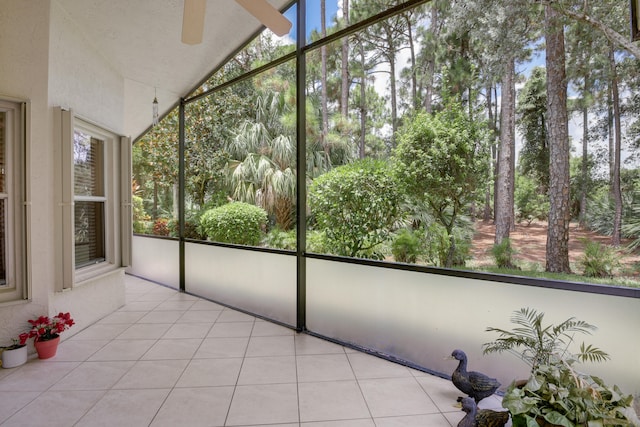 unfurnished sunroom with ceiling fan and lofted ceiling