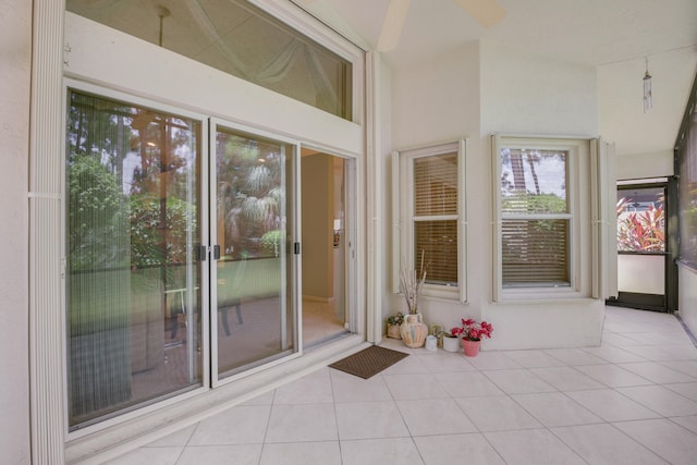 unfurnished sunroom featuring ceiling fan and lofted ceiling