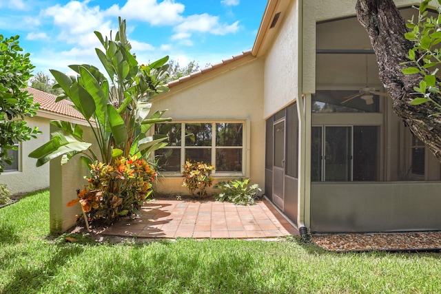 exterior space with a yard, a patio area, and a sunroom