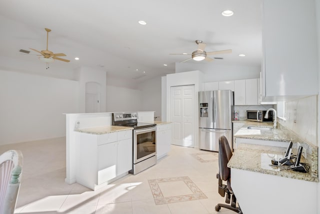 kitchen with white cabinets, sink, stainless steel appliances, and vaulted ceiling