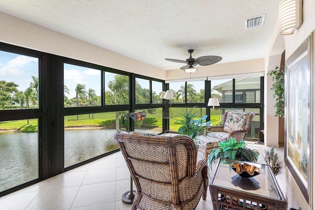 sunroom / solarium with ceiling fan, a water view, and plenty of natural light