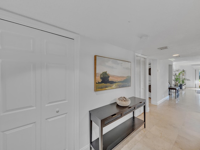 hallway featuring light tile patterned floors