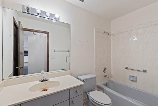 full bathroom with vanity, tiled shower / bath combo, and toilet