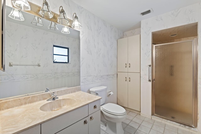 bathroom featuring toilet, tile patterned floors, walk in shower, tile walls, and vanity