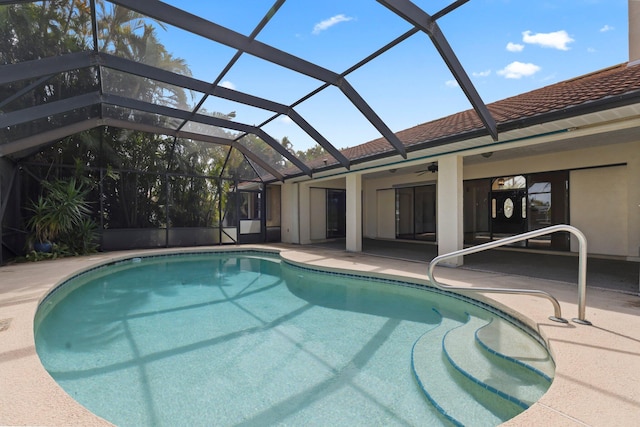 view of swimming pool featuring a patio area and a lanai