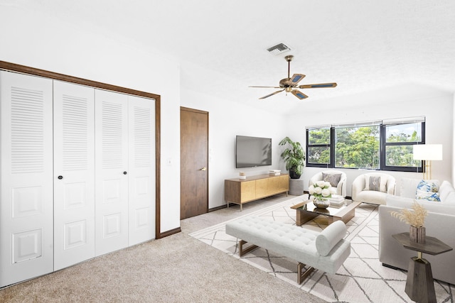 living room featuring light colored carpet and ceiling fan