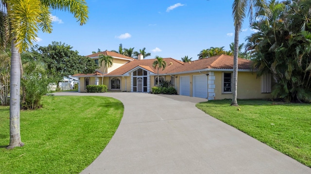 view of front of house with a front yard and a garage