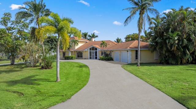 view of front facade with a garage and a front lawn