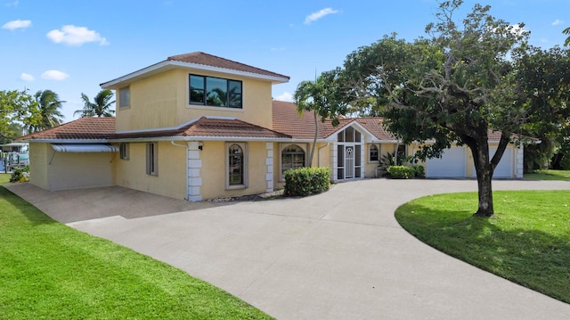 mediterranean / spanish-style home with a front lawn and a garage