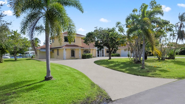 view of front facade featuring a garage and a front lawn