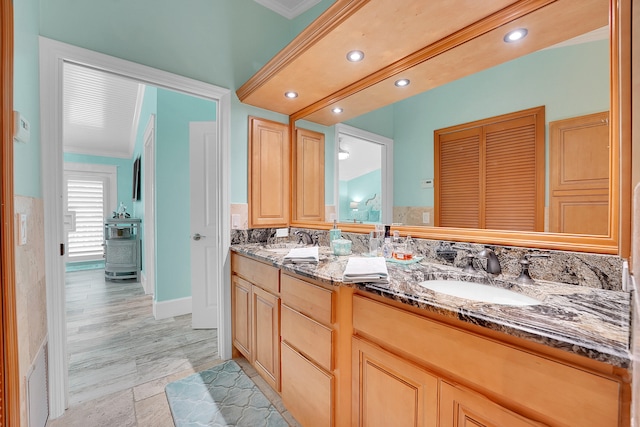 bathroom with vanity and crown molding