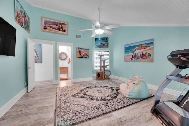 interior space featuring ceiling fan, light hardwood / wood-style floors, ornamental molding, and lofted ceiling