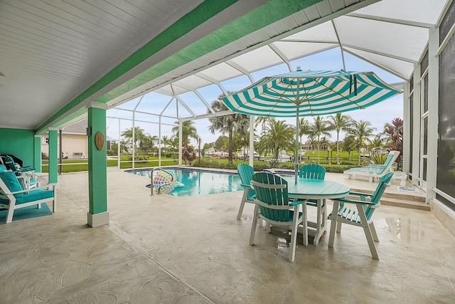 view of swimming pool featuring glass enclosure and a patio area