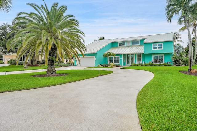 view of front of property with a garage and a front lawn