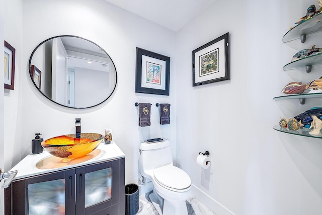 bathroom with vanity, tile patterned flooring, and toilet