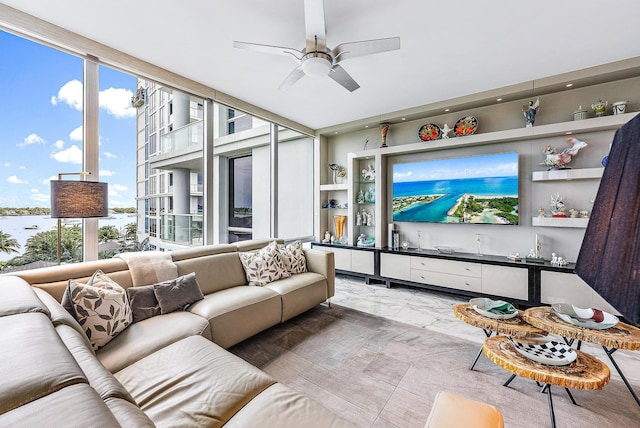 living room with expansive windows and ceiling fan