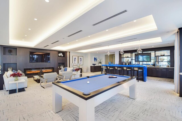 playroom with pool table and a tray ceiling