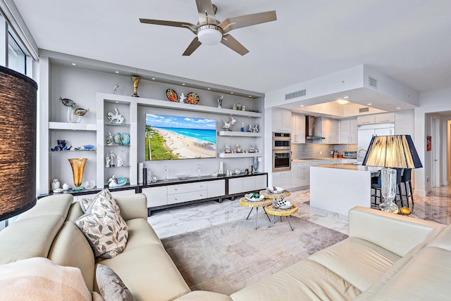 living room featuring light wood-type flooring and ceiling fan